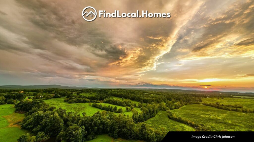 A picturesque view of Jasper, Ga, featuring lush pastures, and a cloudy sky.